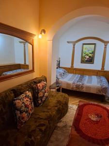 a living room with a couch and a bed at Atgiris in Palanga