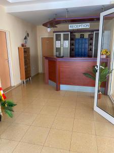 a reception desk in a room with a tile floor at Мирели in Ravda
