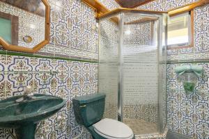 a bathroom with a toilet and a sink at The Ceiba Villa by Otium in Aguas Claras