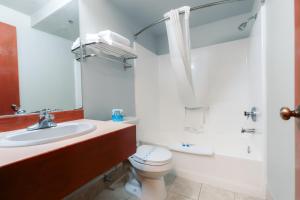 a white bathroom with a toilet and a sink at Bay City Inn in Bellingham +22 photos