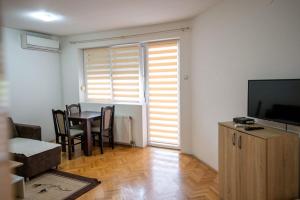 a living room with a table and a television at Apartman in Trebinje