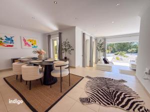 a dining room with a table and a zebra rug at Villa Nichan - Private Pool - NIC01 in Ayamonte