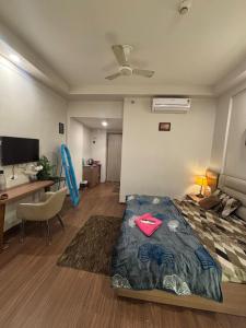 a hotel room with a bed and a desk and a computer at Kervan stays in Greater Noida