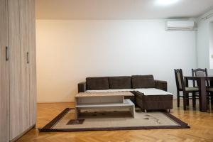 a living room with a couch and a table at Apartman in Trebinje