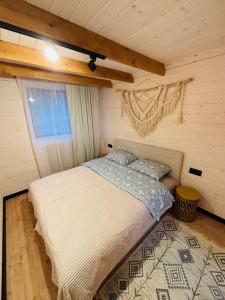 a bedroom with a bed in a wooden room at Carpathian Barns in Abranka