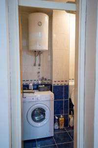 a small bathroom with a washing machine in it at Apartman in Trebinje