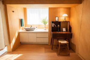 a bathroom with a sink and a desk and a window at On Stay - Hotel Quality Stay in Seoul +76 photos