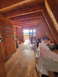 a living room with a table and chairs in a cabin at Cozy Cabin in avocado farm in Marinilla