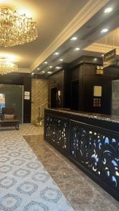 a hotel lobby with a reception desk and a chandelier at شقق فندقية 2 in Buraydah