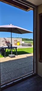a patio with an umbrella and a picnic table at Chata Heřmaň in Heřmaň