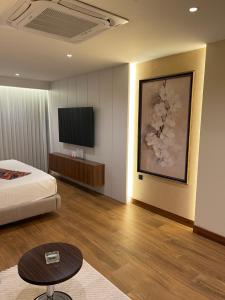 a hotel room with a bed and a television at Zamzam Hotel 1 in An Najaf
