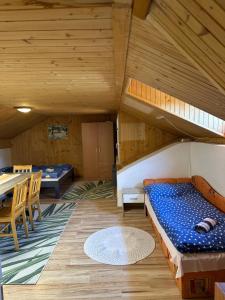 a room with a bunk bed and a table at Apartmán Gál 2 in Kvačany