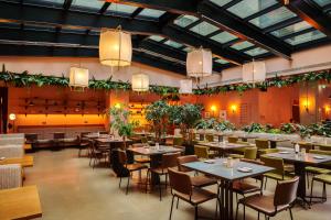 a restaurant with tables and chairs and plants at Beckett Locke in Dublin