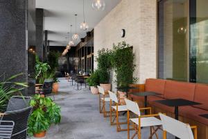 a restaurant with tables and chairs and plants at Beckett Locke in Dublin