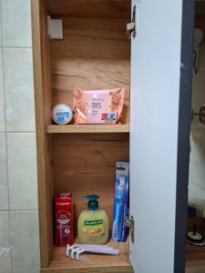 a bathroom cabinet with some toiletries on it at Apartmani Jet Set in Bor