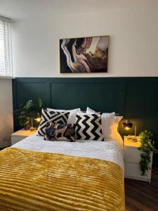a bedroom with a large bed with a yellow blanket at The Recharge Loft in Durham +7 photos