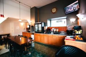 a fast food restaurant with a table and a television at Bay City Inn in Bellingham
