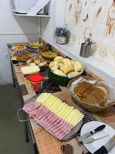 a table topped with lots of different types of food at Hotel Beira Rio Guararema in Guararema +17 photos