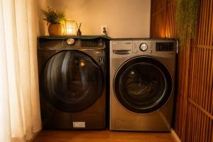 a washing machine and a dryer in a room at On Stay - Hotel Quality Stay in Seoul