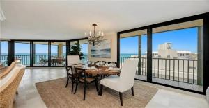 a dining room with a table and views of the ocean at Oceanview Serenity Escape in Naples