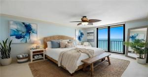 a bedroom with a bed and a ceiling fan at Oceanview Serenity Escape in Naples
