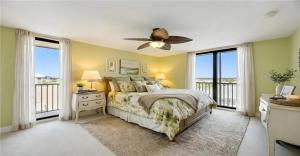 a bedroom with a bed and a ceiling fan at Oceanview Serenity Escape in Naples