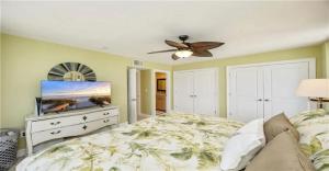a bedroom with a bed and a ceiling fan at Oceanview Serenity Escape in Naples +10 photos