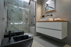 a bathroom with a black sink and a shower at Villa AmOr in Cefalù +30 photos