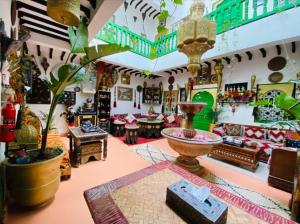 a room filled with lots of furniture and a table at riad cherif in Marrakesh +48 photos