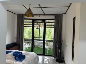 a bedroom with a bed and a view of a patio at Hill Nest Ella in Bandarawela