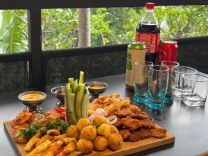 a table with a cutting board with food on it at Hill Nest Ella in Bandarawela