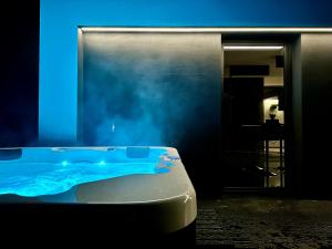 a bath tub in a room with a blue light at The East House ONE in Łapanów