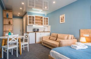 a bedroom with a bed and a kitchen with a table at Atrium New Gudauri GN in Gudauri