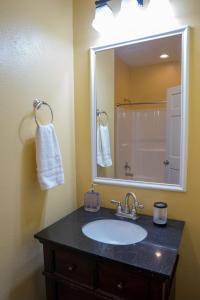 a bathroom with a sink and a large mirror at Ground Floor, 3BR, Free Parking, Near Refinery -E- in Moss Point +15 photos