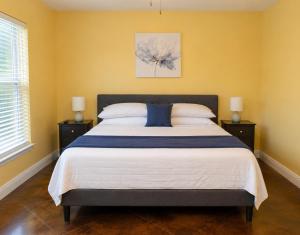 a bedroom with a large bed with yellow walls at Ground Floor, 3BR, Free Parking, Near Refinery -E- in Moss Point