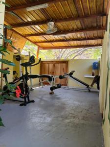 a gym with several treadmills and machines in a room at Finca Paraiso retiros holisticos in San Clemente