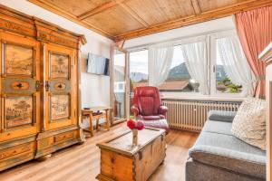 a living room with a couch and a table at Landhaus Pichler mit Sauna in Ruhpolding