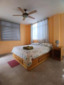 a bedroom with a bed and a ceiling fan at Finca Paraiso retiros holisticos in San Clemente