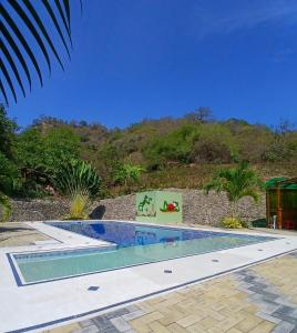 a swimming pool in front of a mountain at Finca Paraiso retiros holisticos in San Clemente