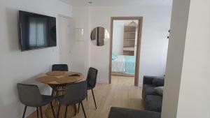 a living room with a table and chairs at Appartement lena in Boulogne-sur-Mer