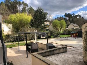a patio with a picnic table and a canopy at Villa avec Piscine in Brive-la-Gaillarde