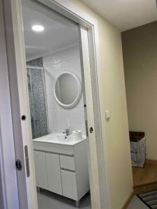 a bathroom with a sink and a mirror at Lajes guests house in Lajes