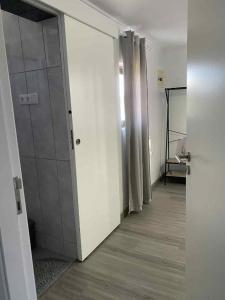 an empty room with a hallway with white walls at Lajes guests house in Lajes