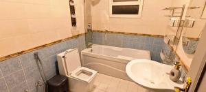 a bathroom with a toilet and a sink at La Casa Beduina Hostel in Riyadh +14 photos