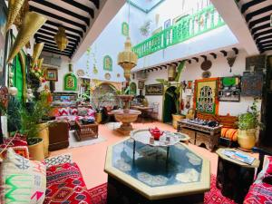 a room filled with lots of furniture and a table at riad cherif in Marrakesh