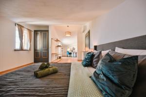 a bedroom with a large bed with a teddy bear on it at Villa Bogijeva in Rabac