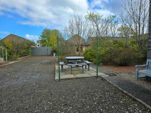a picnic table and a bench in a yard at 16 Northcote Street, Wick in Wick