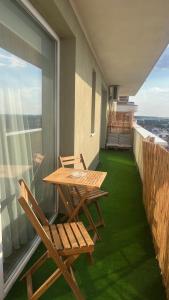 two chairs and a table on a balcony with a view at ZBI Apartament in Oradea