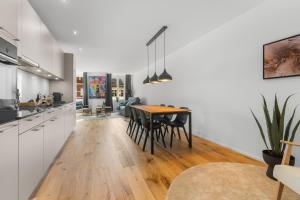 a kitchen and dining room with a table and chairs at Chez Fridolin in Glarus