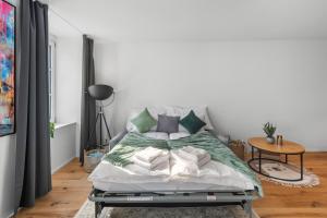 a bed with green and white pillows in a room at Chez Fridolin in Glarus +29 photos